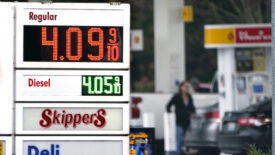 A gas station sign shows the price of regular gas in red numbers as $4.09. 