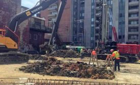 An excavator digs on a project site 