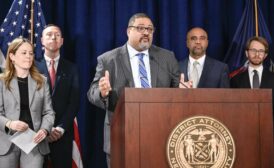 DA Alvin Bragg at a lectern 