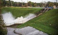 Water runs over Edenville Dam
