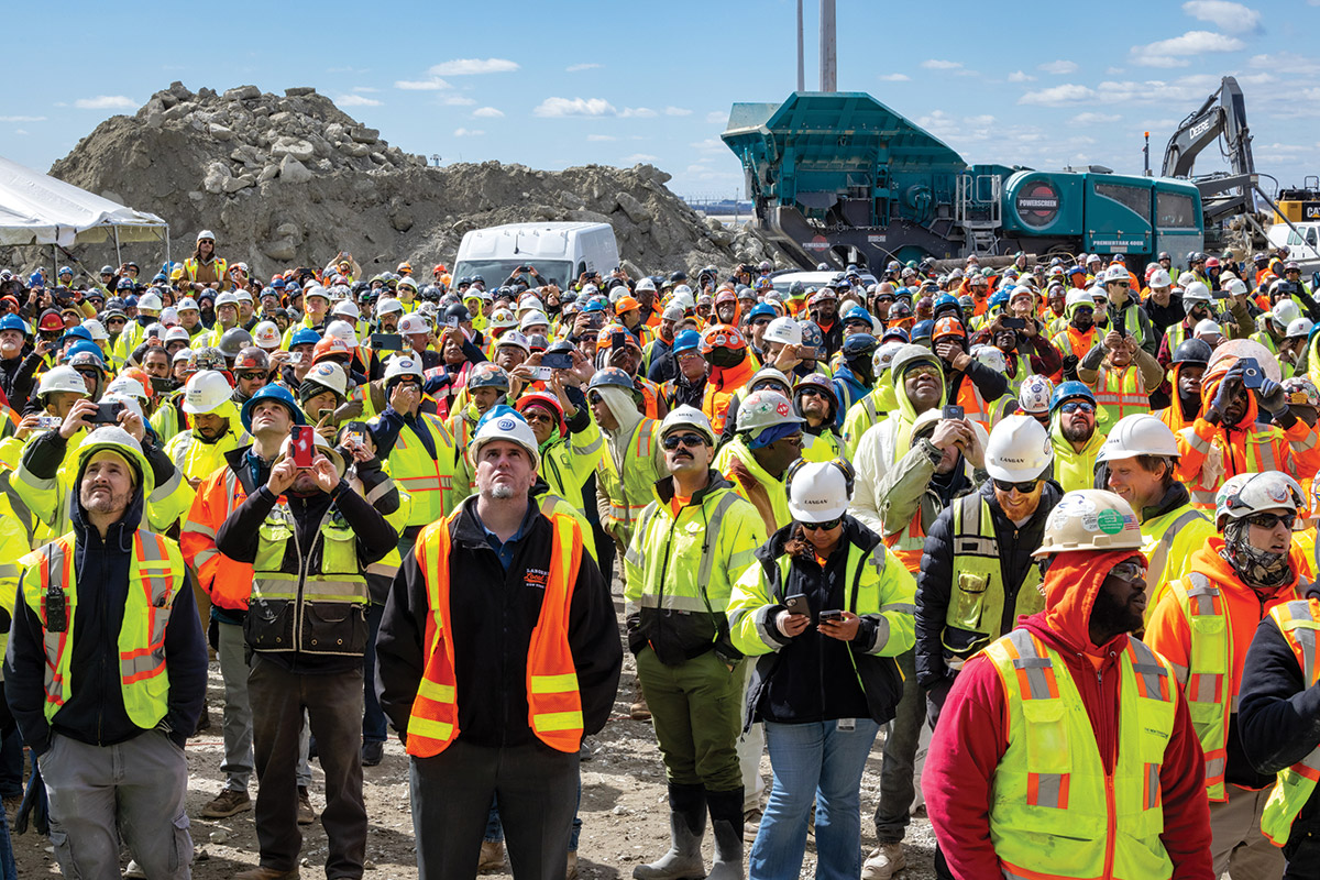 workers watch final beam