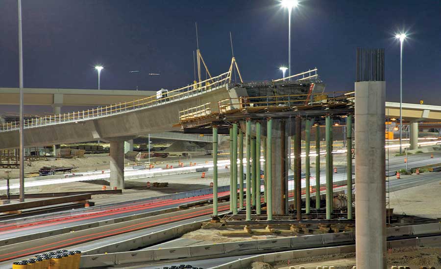 Employees with the Nevada Department of Transportation and Las Vegas Paving  Corp. celebrate the opening of the Centennial Bowl flyover bridge linking  westbound 215 Beltway and southbound U.S. High …