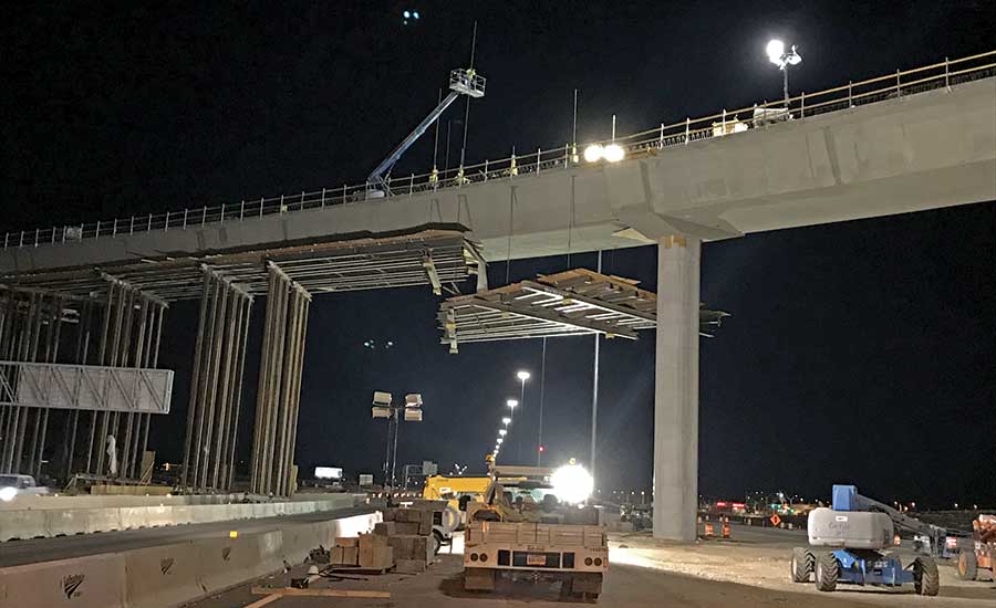 Employees with the Nevada Department of Transportation and Las Vegas Paving  Corp. celebrate the opening of the Centennial Bowl flyover bridge linking  westbound 215 Beltway and southbound U.S. High …