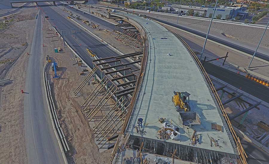 Employees with the Nevada Department of Transportation and Las Vegas Paving  Corp. celebrate the opening of the Centennial Bowl flyover bridge linking  westbound 215 Beltway and southbound U.S. High …